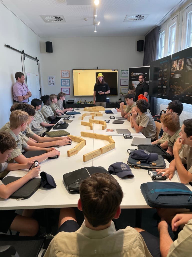 Students working with Micromelon Rovers in a classroom